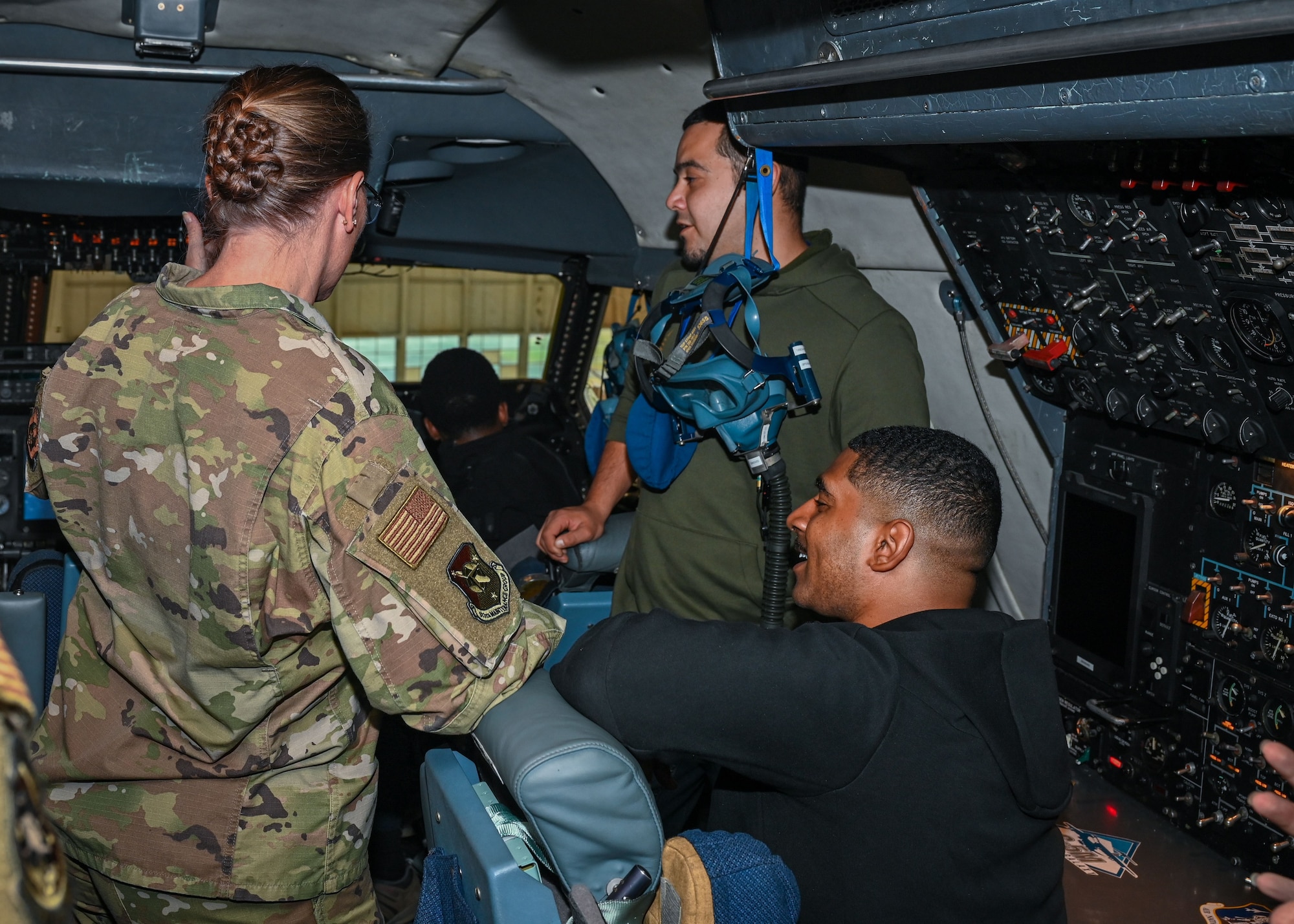 Master Sgt. Carrie Huot, 512th Development and Training Flight chief, and two DTF members, talk inside the flight deck of a C-5M Super Galaxy aircraft. As the DTF instructor, Huot is responsible for providing training and readiness opportunities that prepare newly-enlisted trainees for Basic Military Training. (U.S. Air Force photo by Senior Airman Shayna Hodge)