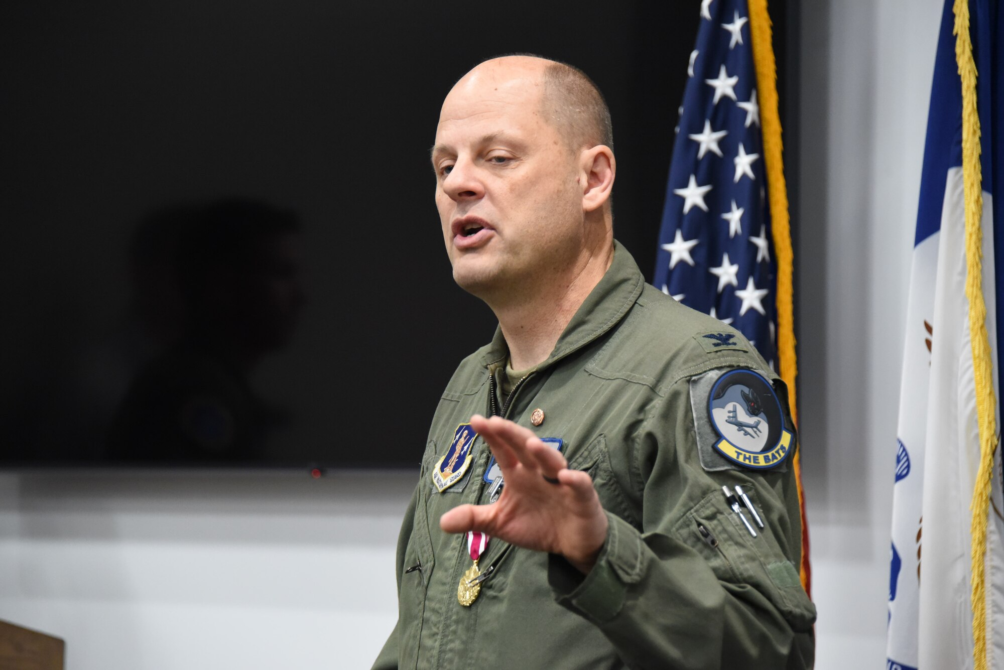 U.S. Air National Guard Col. Kevin Alons, Director of Operations for Air for the Iowa Air National Guard, speaks to an audience
