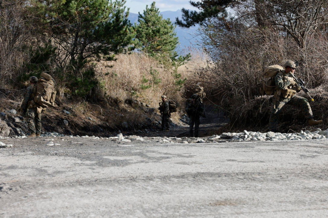 U.S. Marines with 2d Battalion, 7th Marine Regiment move to their objective during Stand-in Force Exercise 24 at Combined Arms Training Center Camp Fuji, Japan, Dec. 3, 2023. SIFEX 24 is a division-level exercise involving all elements of the Marine Air-Ground Task Force focused on strengthening multi-domain awareness, maneuver, and fires across a distributed maritime environment. This exercise serves as a rehearsal for rapidly projecting combat power in defense of allies and partners in the region. 2/7 is forward deployed in the Indo-Pacific under 4th Marine Regiment, 3d Marine Division as part of the Unit Deployment Program. (U.S. Marine Corps photo by Cpl. Scott Aubuchon)