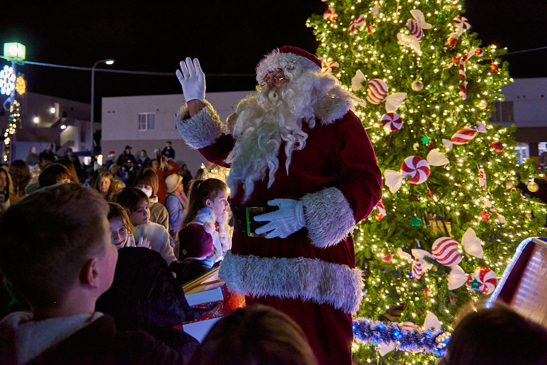 Santa Claus waves to a crowd of children at the Yokosuka Christmas Tree Lighting.