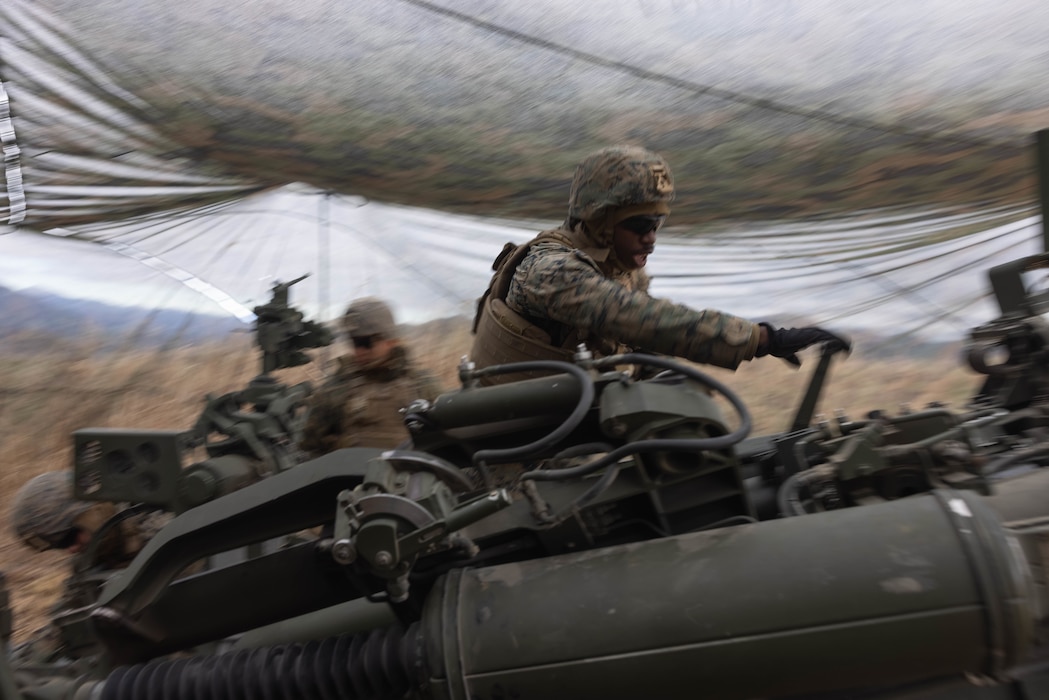 U.S. Marine Corps Lance Cpl. Johnathan Linney prepares to fire an M777 Howitzer during Artillery Relocation Training Program 23.3 in the North Fuji Maneuver Area at Combined Arms Training Center Camp Fuji, Japan, Nov. 25, 2023. The skills developed at ARTP increase the proficiency and readiness of the only permanently forward-deployed artillery unit in the Marine Corps, enabling them to provide indirect fires. Linney, a native of Fayetteville, North Carolina, is an artilleryman with Alpha Battery, 3d Battalion, 12th Marine Littoral Regiment, 3d Marine Division. (U.S. Marine Corps photo by Sgt. Alyssa Chuluda)