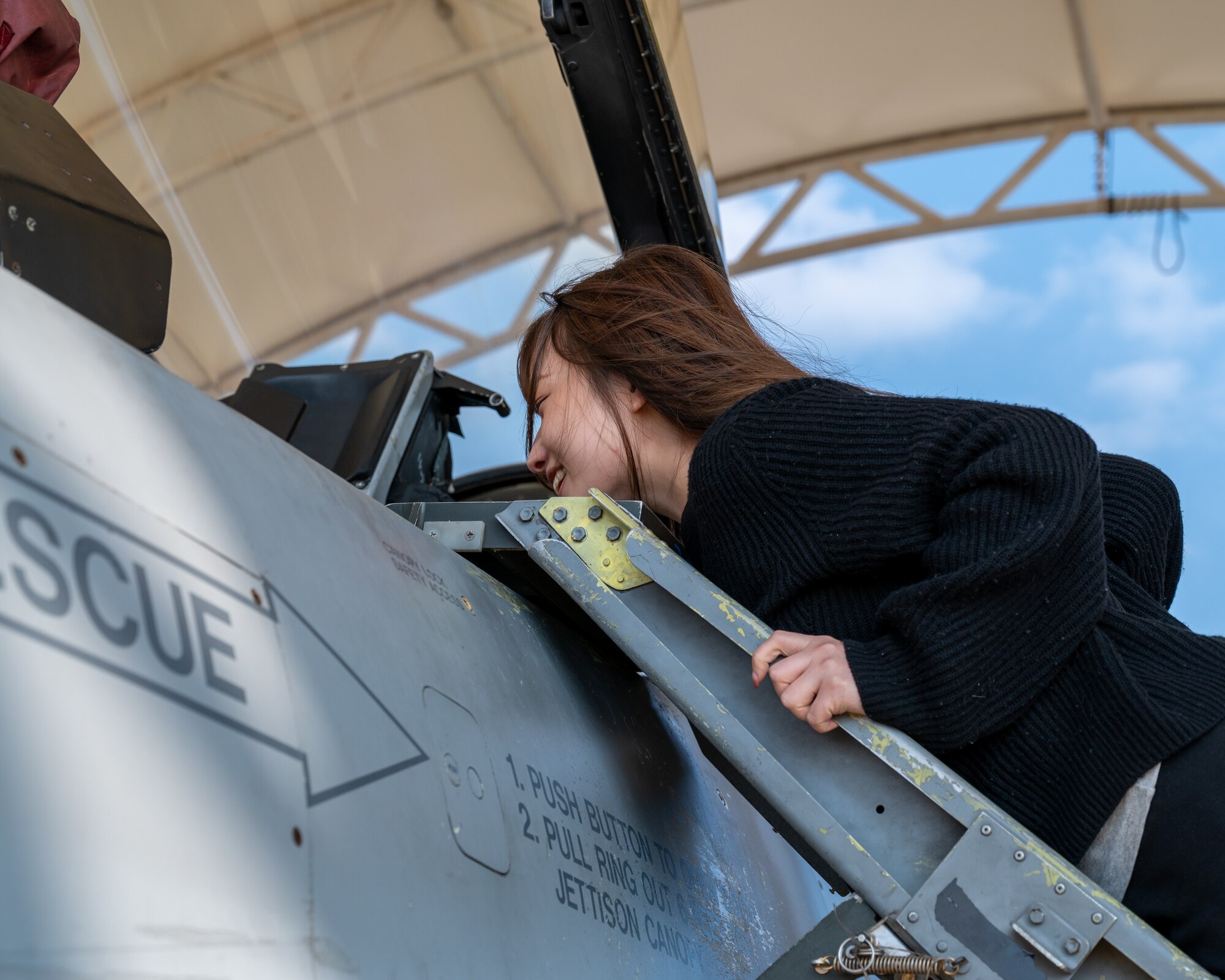 Hannah Cho looks inside the cockpit of an F-16 Fighting Falcon during a base tour at Kunsan Air Base.