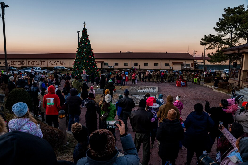 Members of Osan community gather during the Christmas Tree Lighting Ceremony outside the base theater at Osan Air Base, Republic of Korea, Dec. 1, 2023.