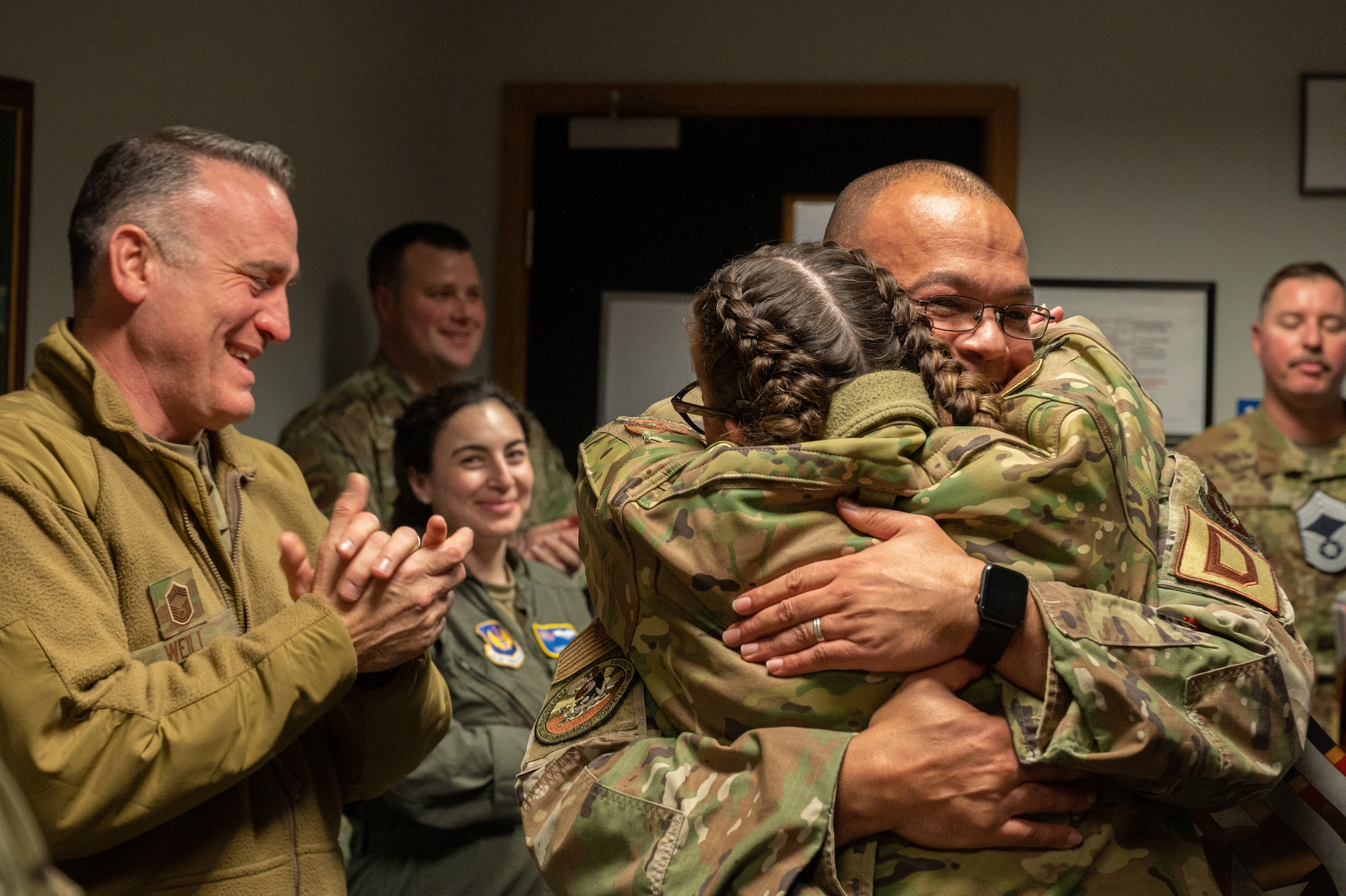 U.S. Air Force Senior Master Sgt. Patricia “Patti” Jones, left, 100th Maintenance Group maintenance operations flight senior enlisted leader, celebrates with Senior Master Sgt. Jerome Lundy, right, 100th MXG quality assurance superintendent, upon notification of their upcoming promotion to the rank of chief master sergeant at Royal Air Force Mildenhall, England, Nov. 29, 2023.