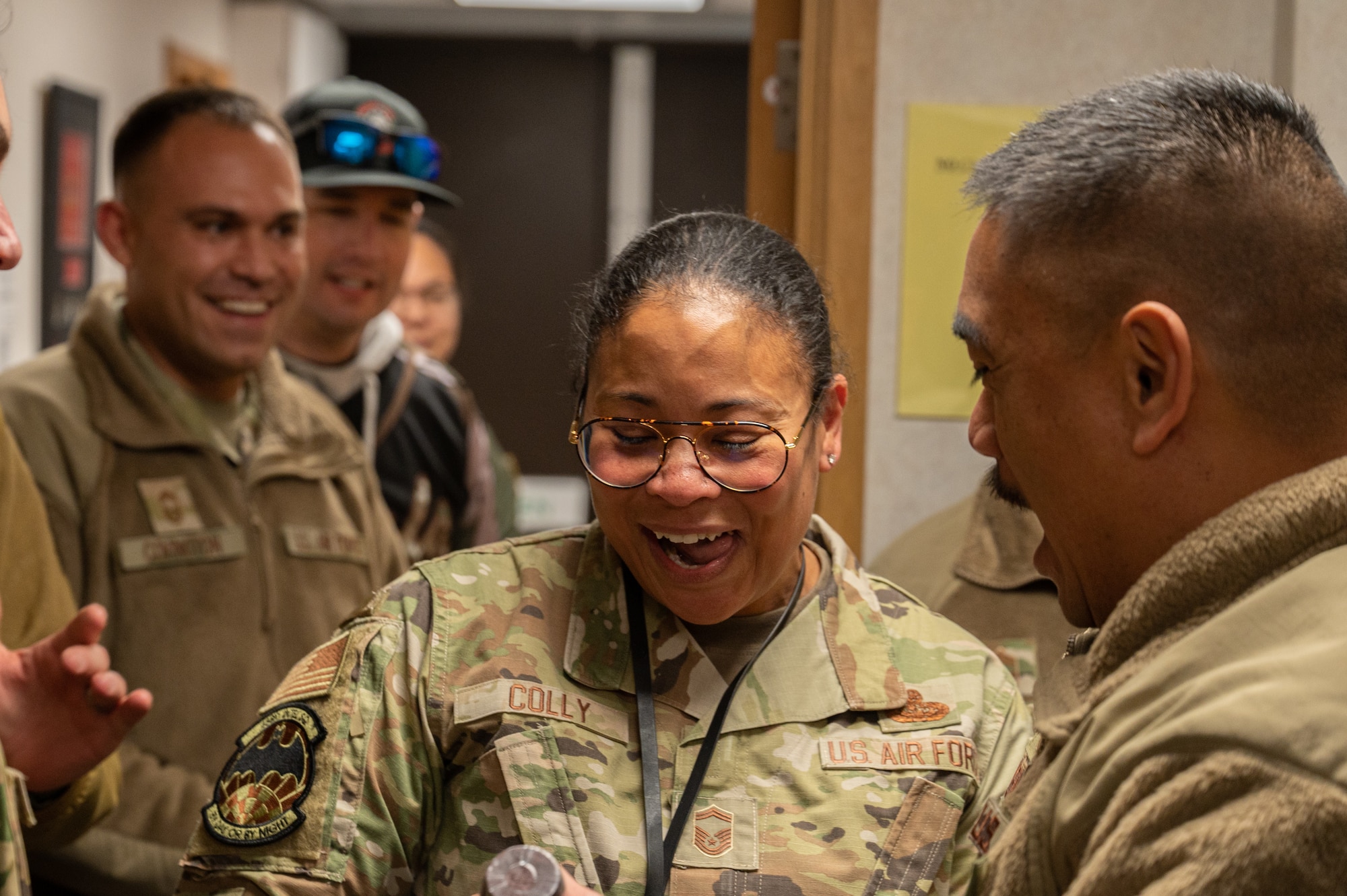 U.S. Air Force Senior Master Sgt. Catherine Colly, 488th Intelligence Squadron superintendent, smiles as she receives notification that she will promote to the rank of chief master sergeant at Royal Air Force Mildenhall, England, Nov. 29, 2023.