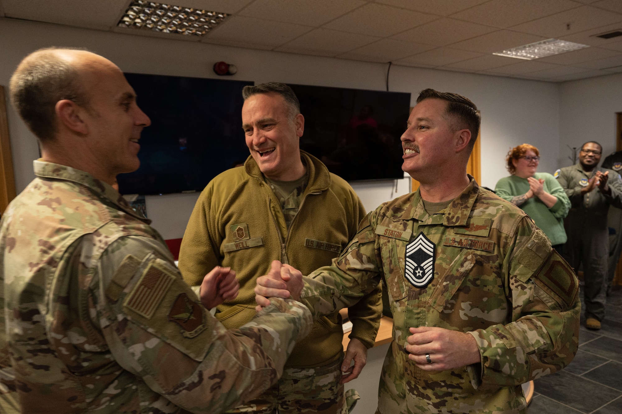 U.S. Air Force Col. Mark McGill, left, 352d Special Operations Wing commander, congratulates Senior Master Sgt. Christopher Staton, right, 351st Air Refueling Squadron senior enlisted leader, after being notified that he will promote to the rank of chief master sergeant at Royal Air Force Mildenhall, England, Nov. 29, 2023.