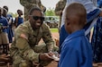 Capt. Dominique Mosbly, U.S. Southern European Task Force, Africa (SETAF-AF) Civil Affairs Team 21 Chief provides a Ghanaian youth with a personal hygiene product at a school in Northern Ghana. Team 21 coordinated with the Ghanaian Armed Forces to deliver multiple donations of personal hygiene products to children at several local schools in Northern Ghana during their deployment to Africa in support of SETAF-AF. The 412th Civil Affairs Battalion, part of the 360th Civil Affairs Brigade, 352nd Civil Affairs Command, assisted with the coordination and execution of multiple civil-military events during their 9-month deployment to Africa in support of SETAF-AF. (Photo courtesy of 412th Civil Affairs Battalion.)