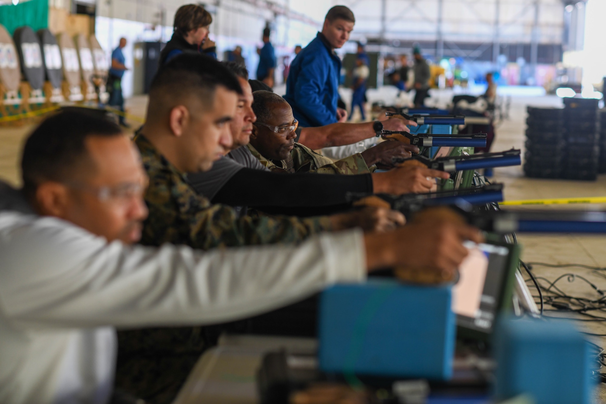 Air Force Wounded Warrior Program volunteers shoot air pistols during the 2023 Warrior CARE Week at Joint Base Andrews