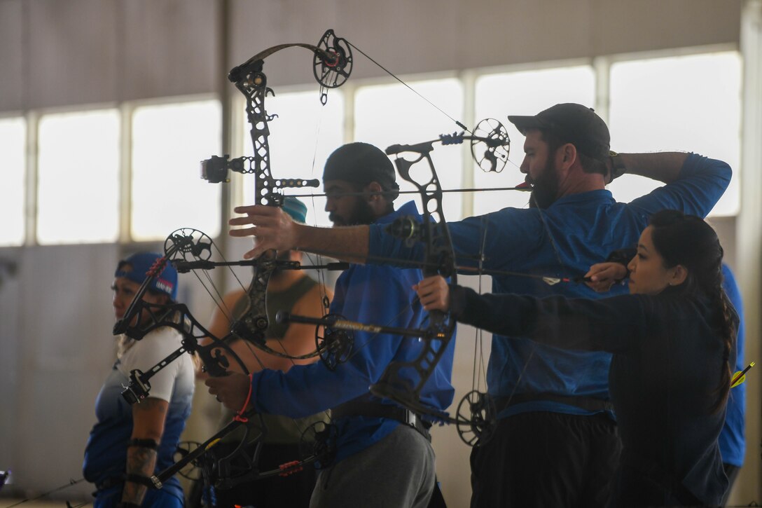 Air Force Wounded Warrior Program volunteers shoot bows during the 2023 Warrior CARE Week at Joint Base Andrews