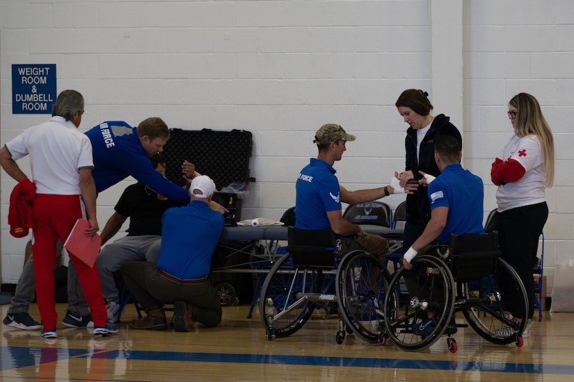 U.S. Air Force Wounded Warrior athletes and volunteers get prepared for competitive wheelchair basketball at Joint Base Andrews