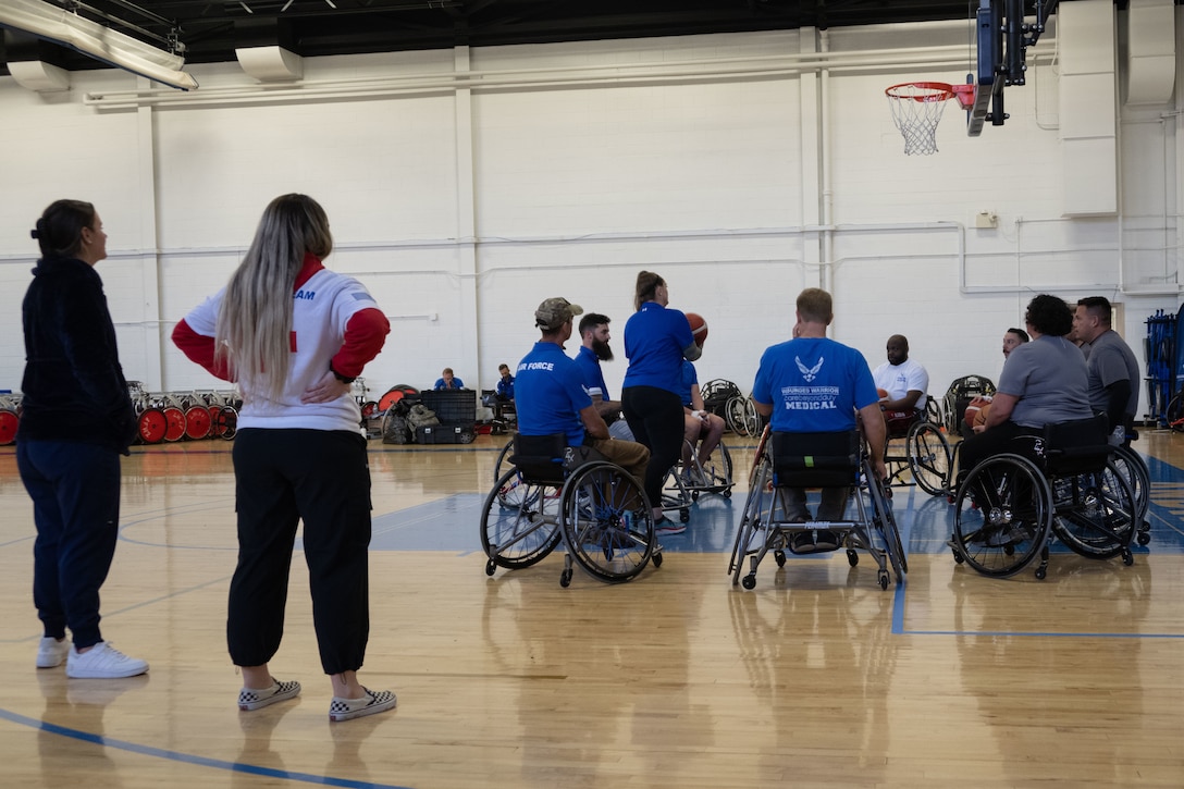 U.S. Air Force Wounded Warrior athletes and volunteers do practice drills before playing competitive wheelchair basketball at Joint Base Andrews