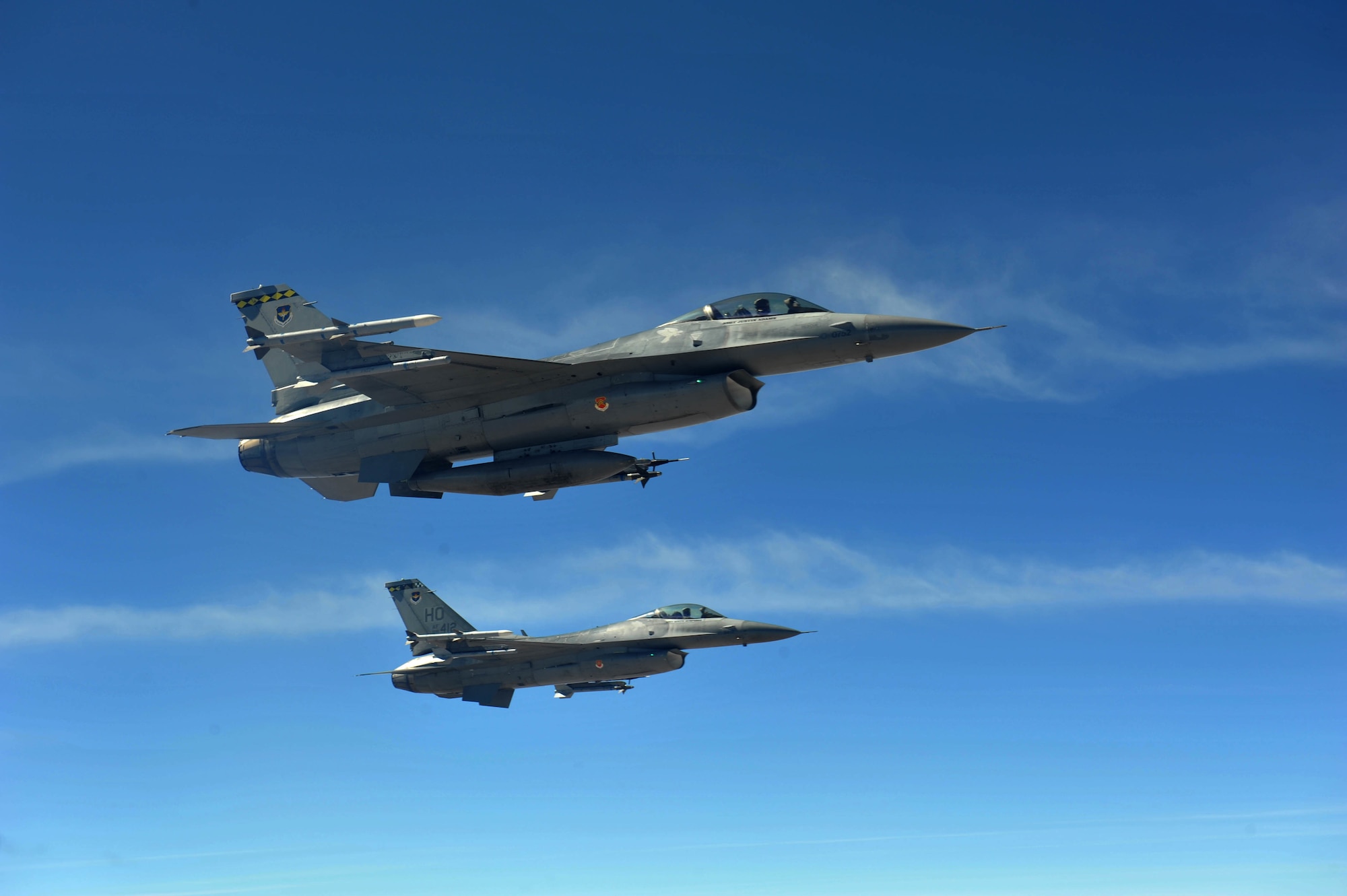 Two F-16 Fighting Falcons fly in formation.