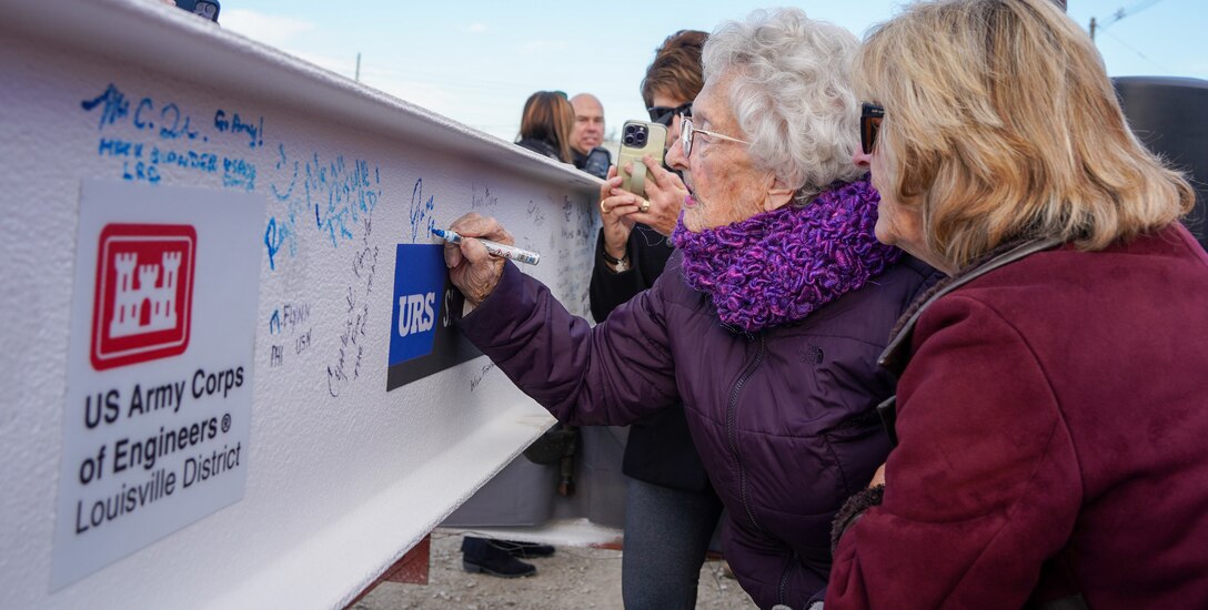 June Friedly, former Robley Rex VA Medical Center employee, signs the beam before it is placed on the new Louisville VA Medical Center Nov. 30, 2023. Friedly was an employee of the Robley Rex VA Medical Center when it was dedicated in 1952.