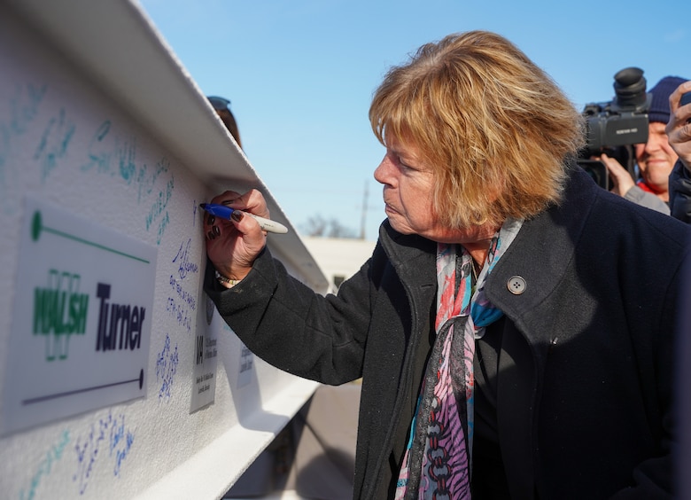 Jo-Ann Ginsberg, executive director of the Robley Rex VA Medical Center, signs the beam before it is placed on the new Louisville VA Medical Center Nov. 30, 2023.