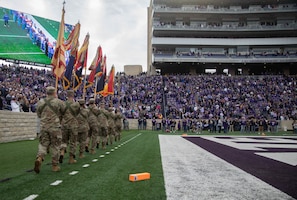 Soldiers assigned to the 1st Infantry Division present the colors before a Veterans Day game at the Bill Snyder Family Stadium, Nov. 11, 2023. The Fort Riley Day game is an annual tradition between Kansas State University and Fort Riley symbolizing their ongoing connection. (U.S. Army photo by Pfc. Koltyn O’Marah)