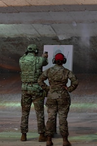 a person monitors another person firing a weapon