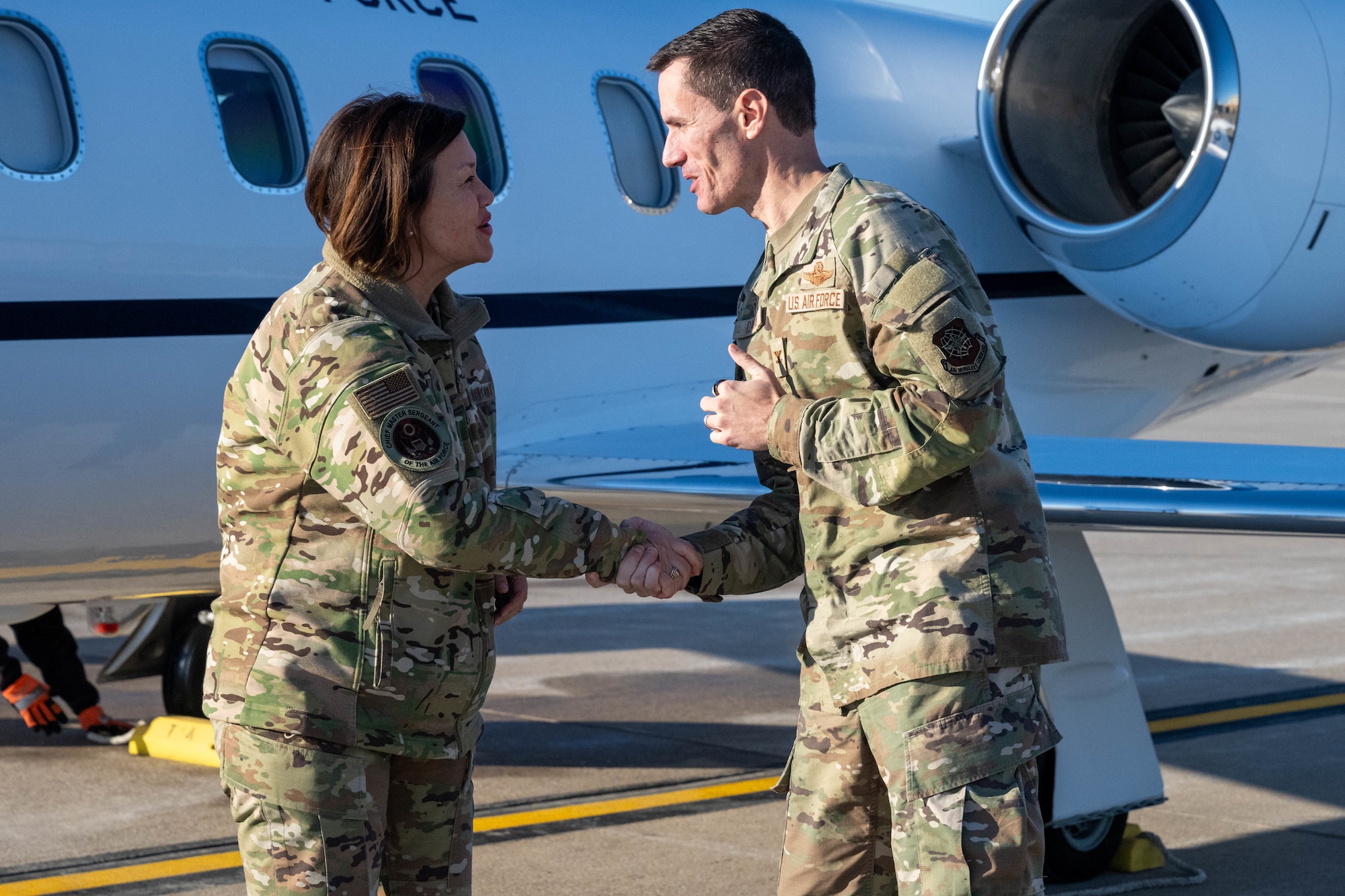 Col. Cory Damon, 22nd Air Refueling Wing commander, right, greets Chief Master Sgt. of the Air Force JoAnne S. Bass Nov. 28, 2023, at McConnell Air Force Base, Kansas. During her visit to McConnell, Bass met with Airmen, toured a KC-46A Pegasus and held an all-call for the team. (U.S. Air Force photo by Airman 1st Class Felicia Przydzial)