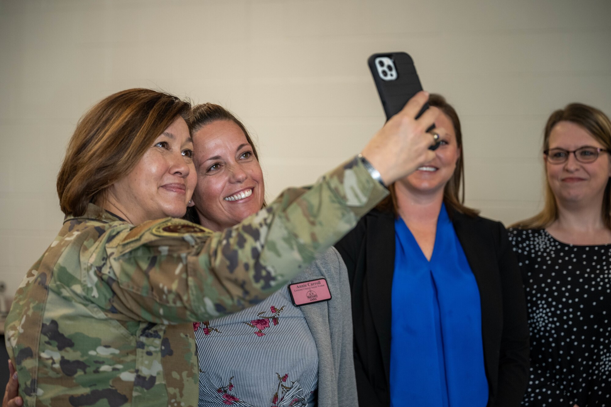 Chief Master Sgt. of the Air Force JoAnne S. Bass takes a photo with Annie Carroll, 22nd and 722nd Aircraft Maintenance Squadron True North clinical social worker, Nov. 29, 2023, at McConnell Air Force Base, Kansas. Agencies from around base met with Bass to discuss their different programs and how they help members of Team McConnell increase resiliency. (U.S. Air Force photo by Airman 1st Class Felicia Przydzial)