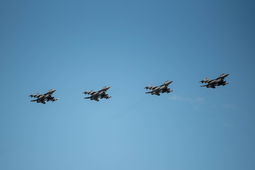 Military fighter jets fly in formation.