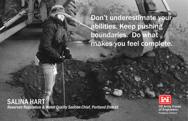 A photo of a woman standing in dirt in front of a crane with the text "Don't underestimate your abilities. Keep pushing boundaries. Do what make you feel complete."