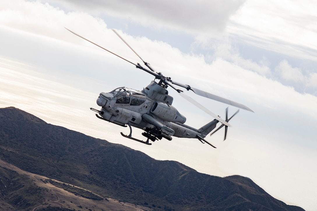 A U.S. Marine Corps AH-1Z Viper with Marine Light Attack Helicopter Squadron (HMLA) 367, Marine Aircraft Group 39, 3rd Marine Aircraft Wing, escorts MV-22B Osprey aircraft with Marine Medium Tiltrotor Squadron (VMM) 164, MAG-39, during embassy reinforcement training in support of Exercise Steel Knight 23.2 at Marine Corps Base Camp Pendleton, California, Nov. 29, 2023.  Marines and aircraft with MAG-39 conducted aerial  support for embassy reinforcement training with Marine Rotational Force- Darwin.  Steel Knight 23.2 is a three-phase exercise designed to train I Marine Expeditionary Force in the planning, deployment and command and control of a joint force against a peer or near-peer adversary combat force and enhance existing live-fire and maneuver capabilities of the Marine Air-Ground Task Force. (U.S. Marine Corps photo by Sgt. Potter)