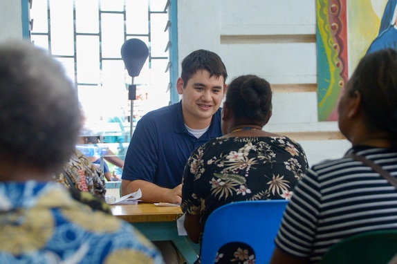 U.S. Navy Lt. Brodrick Hirai, from Kennewick, Washington, counsels a local resident during a community health engagement at the Holy Cross Cathedral in Honiara, Solomon Islands, as part of Pacific Partnership 2024-1, Dec. 2, 2023. Pacific Partnership, now in its 19th iteration, is the largest multinational humanitarian assistance and disaster relief preparedness mission conducted in the Indo-Pacific and works to enhance regional interoperability and disaster response capabilities, increase security stability in the region, and foster new and enduring friendships. (U.S. Navy photo by Mass Communication Specialist 2nd Class Jacob Woitzel)
