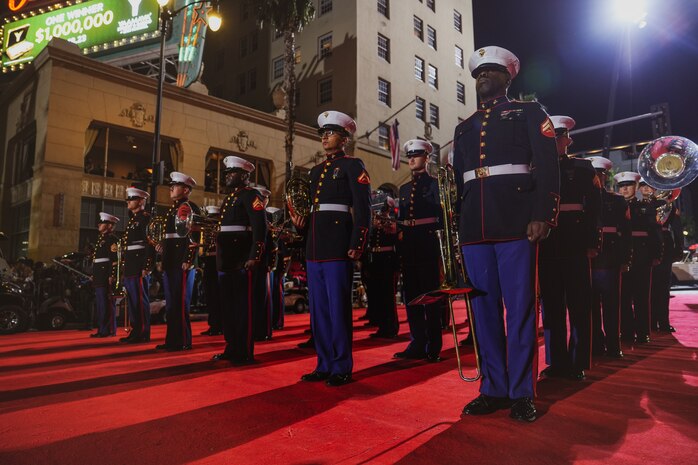 U.S. Marines assigned to Marine Band San Diego, stand at attention during the Hollywood Christmas Parade, in Hollywood, California, Nov. 26, 2023. Marine Band San Diego participated in the parade to improve community relations, increase morale, and demonstrate holiday spirit. (U.S. Marine Corps photo by Lance Cpl. Francisco Angel)