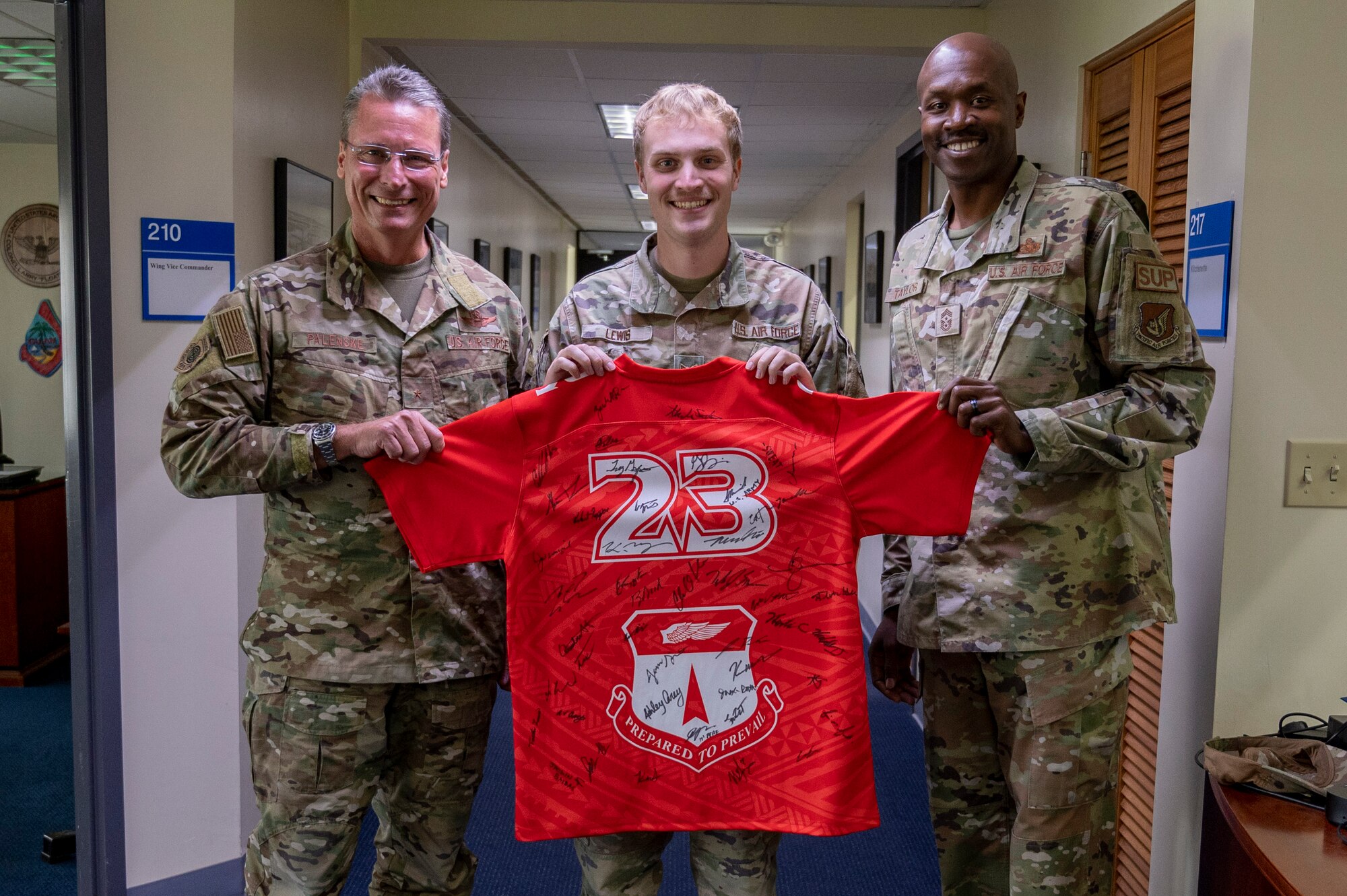 U.S. Air Force Senior Airman Tristan Lewis, a wing administrator for the 36th Wing, receives the Linebacker of the Week Award from U.S. Air Force Brig. Gen. Thomas Palenske, 36th Wing commander, and U.S. Air Force Chief Master Sgt. Nicholas Taylor, 36th Wing command chief, at Andersen Air Force Base, Guam, Nov. 29, 2023. The Team Andersen Linebacker of the Week recognizes outstanding enlisted, officer, civilian and total force personnel who have had an impact on achieving Team Andersen’s mission, vision and priorities. (U.S. Air Force photo by Senior Airman Emily Saxton)