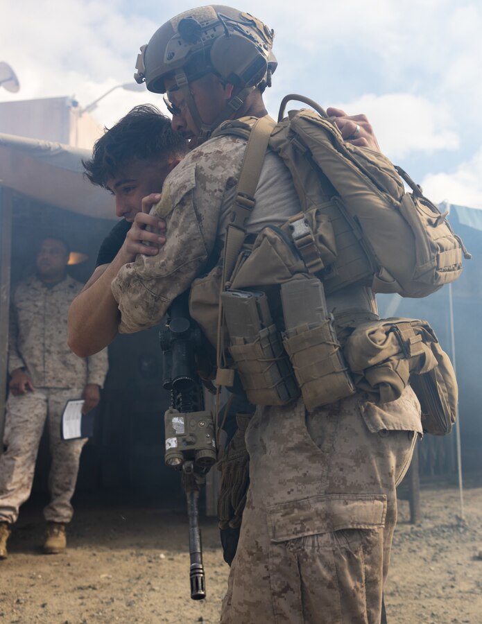 A U.S. Marine with Fox Company, 2nd Battalion, 5th Marine Regiment, 1st Marine Division, assists a simulated civilian casualty to a medical aid station during a mass casualty training scenario for a simulated embassy reinforcement during a mission rehearsal exercise as part of Exercise Steel Knight 23.2 at Marine Corps Base Camp Pendleton, California, Nov. 29, 2023. Steel Knight maintains and sharpens I Marine Expeditionary Force as America’s expeditionary force in readiness – organized, trained and equipped to respond to any crisis, anytime, anywhere. This exercise will certify 5th Marines to be forward-postured in Australia as Marine Rotational Force - Darwin, a six-month deployment during which Marines train with Australian allies and facilitate rapid response to crises and contingencies. (U.S. Marine Corps photo by Cpl. Earik Barton)