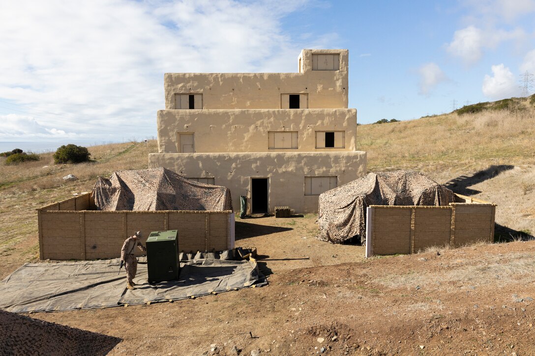 A U.S. Marine with Combat Logistics Battalion 5, Combat Logistics Regiment 1, 1st Marine Logistics Group, prepares a simulated evacuation control center during a mission rehearsal exercise as part of Exercise Steel Knight 23.2 at Marine Corps Base Camp Pendleton, California, Nov. 30, 2023. Steel Knight maintains and sharpens I Marine Expeditionary Force as America’s expeditionary force in readiness – organized, trained and equipped to respond to any crisis, anytime, anywhere. This exercise will certify the battalion and 5th Marine Regiment, 1st Marine Division, to be forward-postured in Australia as Marine Rotational Force - Darwin, a six-month deployment during which Marines train with Australian allies and facilitate rapid response to crises and contingencies. (U.S. Marine Corps photo by Sgt. Cristian Bestul)