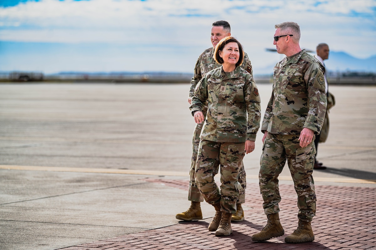 Chief Master Sgt. of the Air Force Joanne Bass (middle), speaks with Brig. Gen. Jason Rueschhoff, 56th Fighter Wing commander (right) and Chief Master Sgt. Jason Shaffer, 56th Fighter Wing command chief (left), upon arrival to the 56th FW.