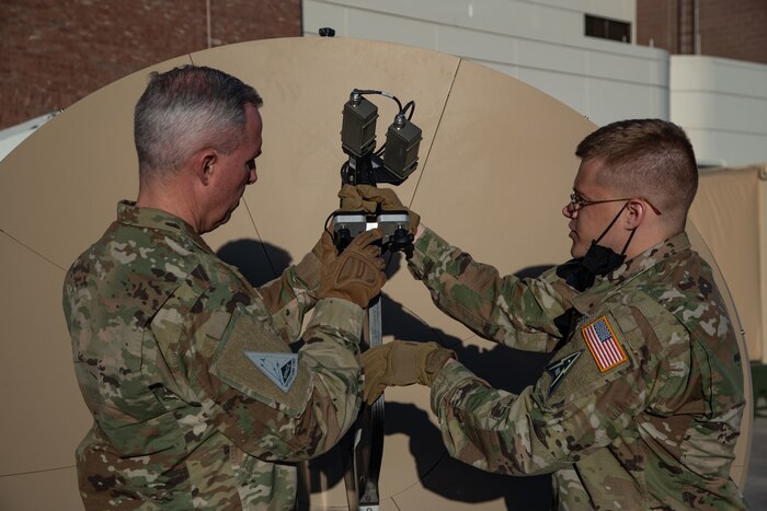 U.S. Space Force Tech. Sgt. John Idleman, Space Delta 3 – electromagnetic warfare, 16th Space Control Squadron mission assurance engineering section chief, demonstrates a feed swap on a Giggasat FA-150 antenna for USSF Lt. Gen. Stephen Whiting, Space Operations Command commander, at Peterson Space Force Base, Colorado, Dec. 13, 2021.