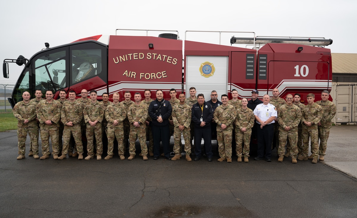 Members of the Hancock Field Air National Guard Fire Department stand for a group photo after receiving the CMSgt Greg O. Winjum award as the 2022 ANG Fire Department of the Year in the small category. The Air National Guard's best fire department is recognized with the award in recognition of achievements in areas such as community relations, training, and fire prevention. (U.S. Air National Guard Photo by SSgt Tiffany Scofield)
