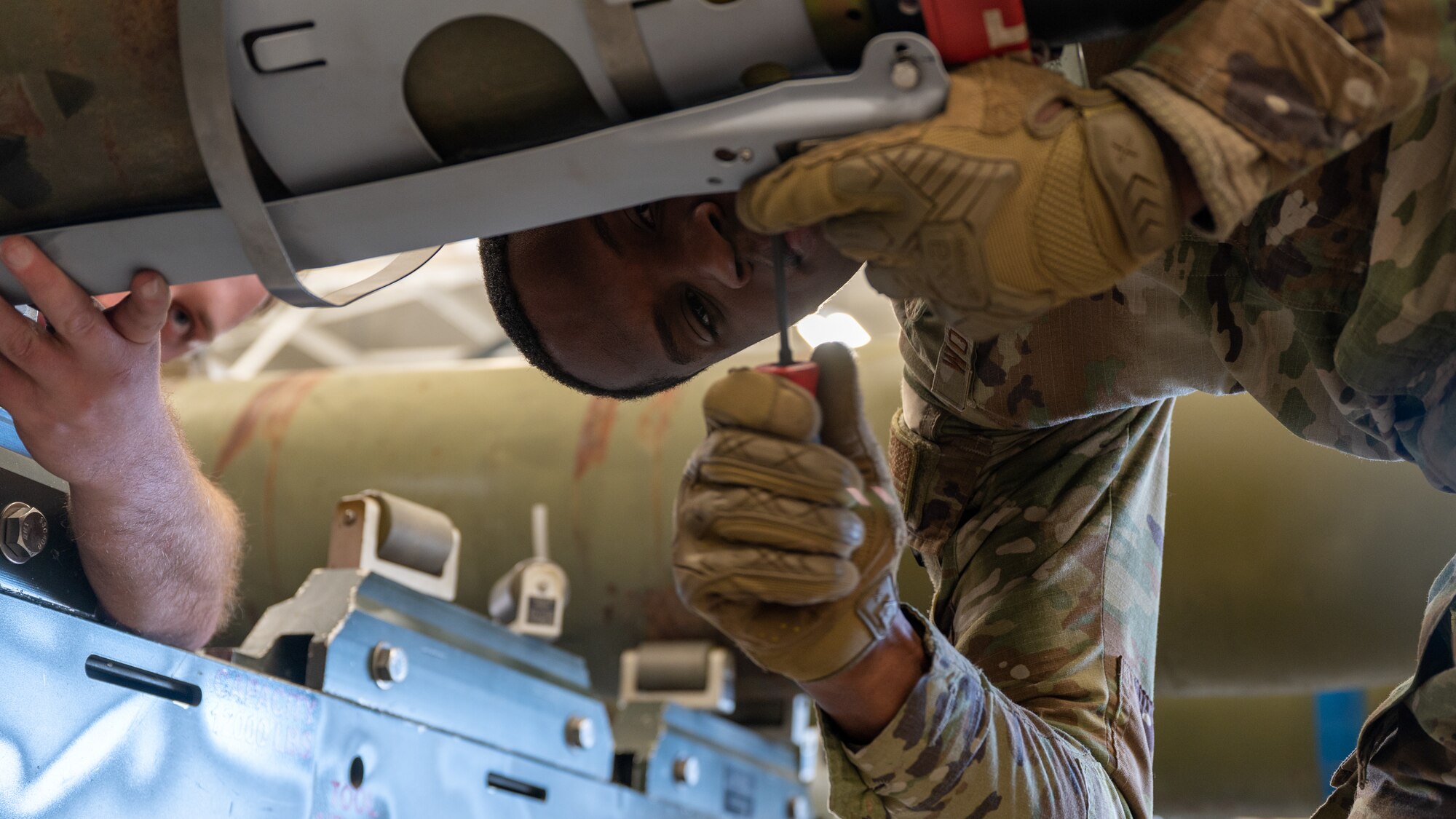 Airman 1st Class Daven Woulard, 8th Maintenance Squadron conventional maintenance technician unscrews the outer casing of a guided bomb unit-54