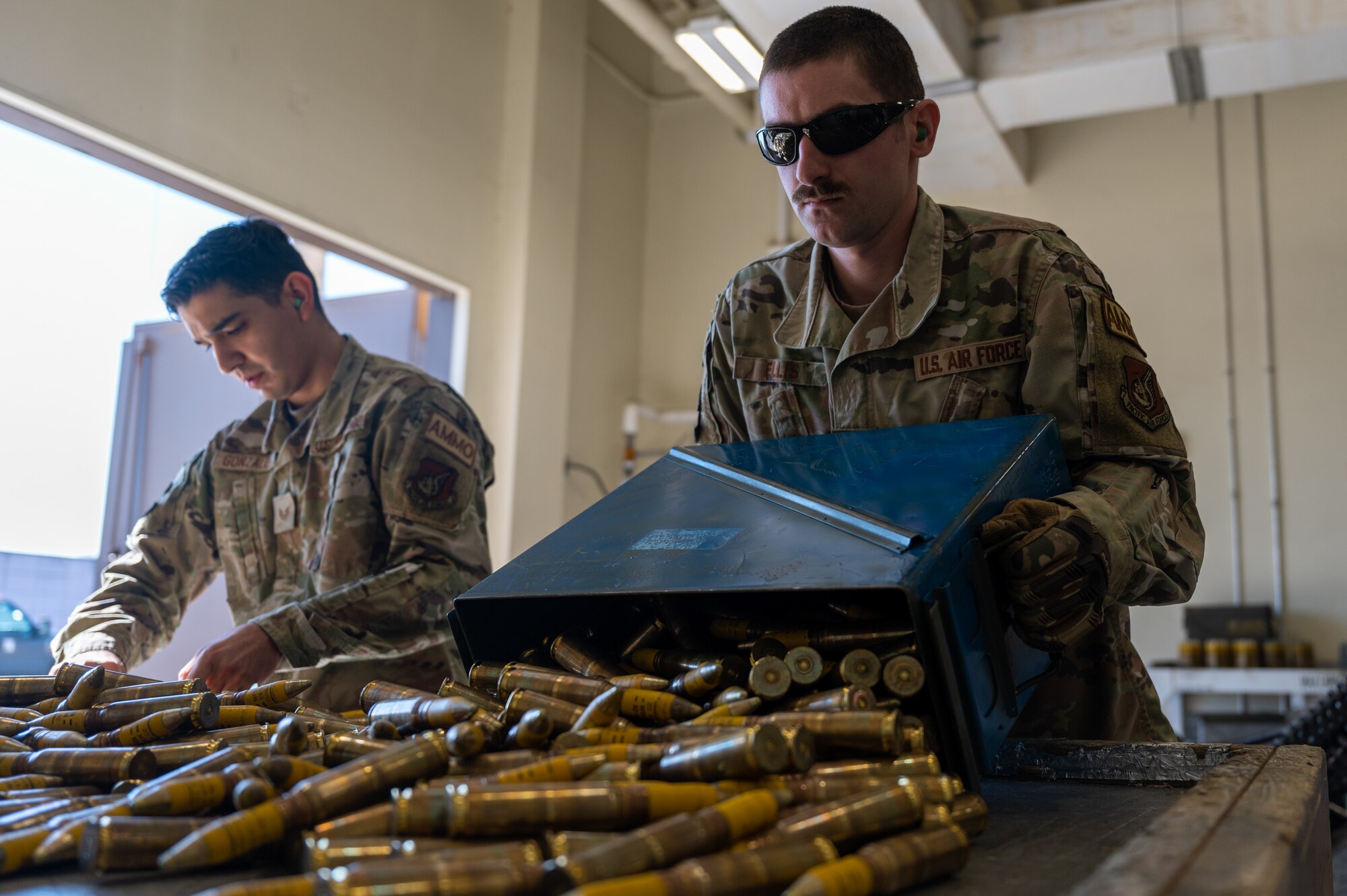 Staff Sgt. Benjamin Ellis, right, 8th Maintenance Squadron conventional maintenance support superintendent, empties an ammunition canister while Staff Sgt. Christopher Gonzalez, 8th MXS conventional maintenance crew chief, sorts 20 mm rounds from the canister
