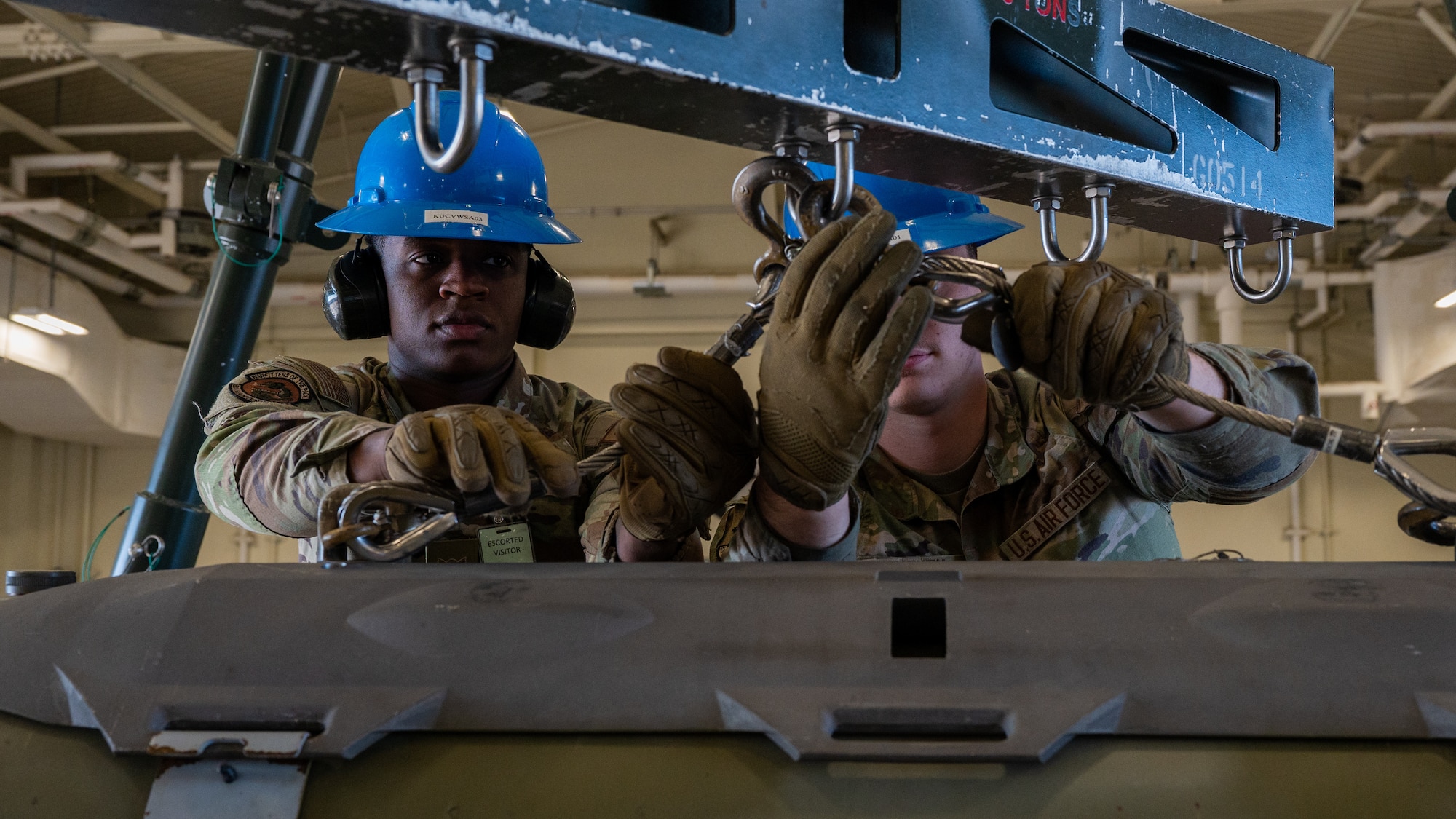 Airman 1st Class Daven Woulard, left, and Airman 1st Class Jerad Leathem, 8th Maintenance Squadron conventional maintenance crew technicians, position a guided bomb unit-31 version 3