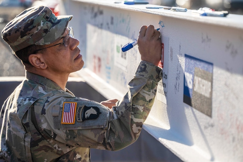 Brig. Gen. Mark C. Quander, commander of the U.S. Army Corps of Engineers Great Lakes and Ohio River Division, signs the beam before it is placed on the new Louisville VA Medical Center Nov. 30, 2023.