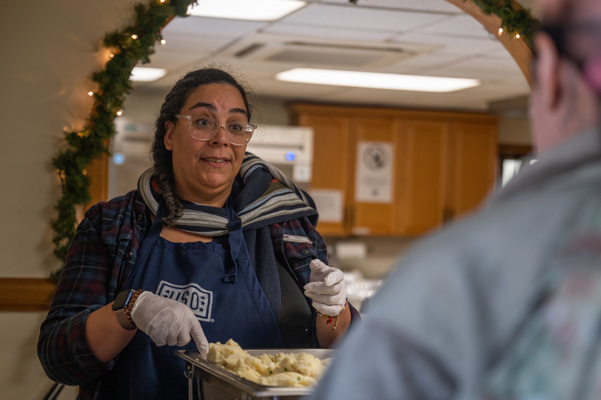 Beth Turner, USO Osan volunteer, provides meal service to Airmen
