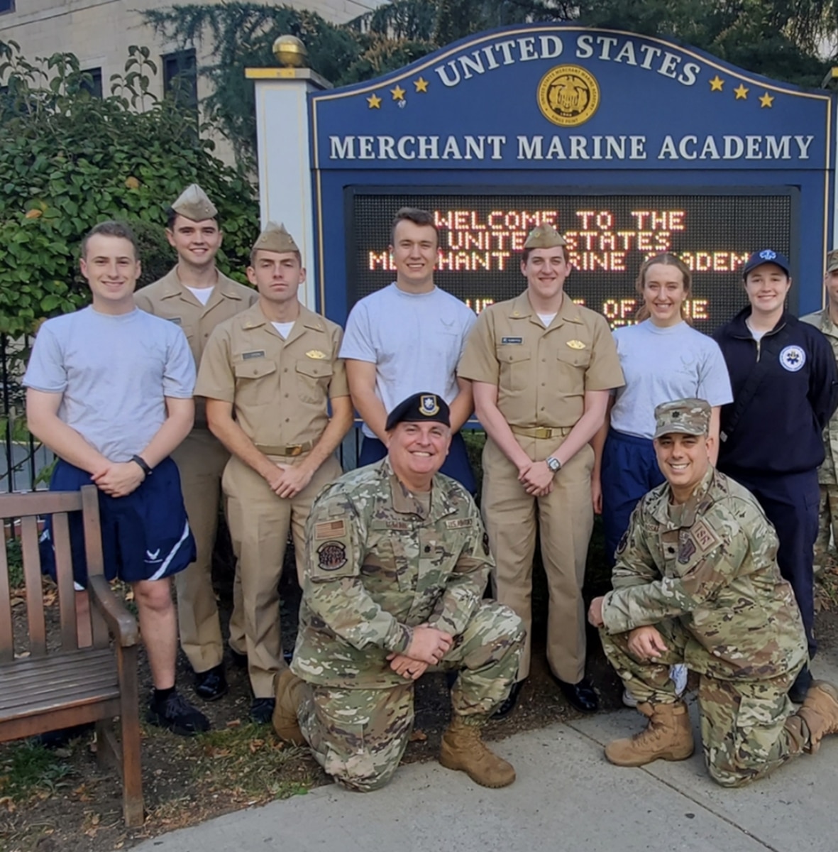 Lt. Col. Nicholas Passarella and Lt. Col. Jason McMunn, Air Force Reserve individual mobilization augmentees, pose with midshipmen cadets at the U.S. Merchant Marine Academy. (Courtesy photo)