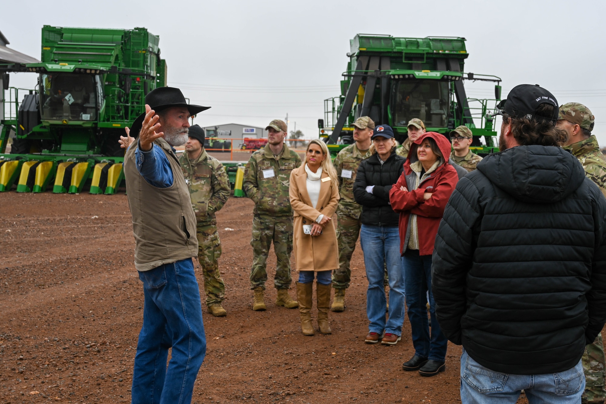 Tom Buchanan, Lugert-Altus Irrigation District manager, talks Airmen from the 97th Air Mobility Wing about cotton harvester machines used at the Cotton Growers Co-op in Altus, Oklahoma, Nov. 30, 2023. This is the 46th year where Airmen and community members have come together to learn more about the role that airpower and agriculture play in national relations (U.S. Air Force photo by Senior Airman Trenton Jancze)