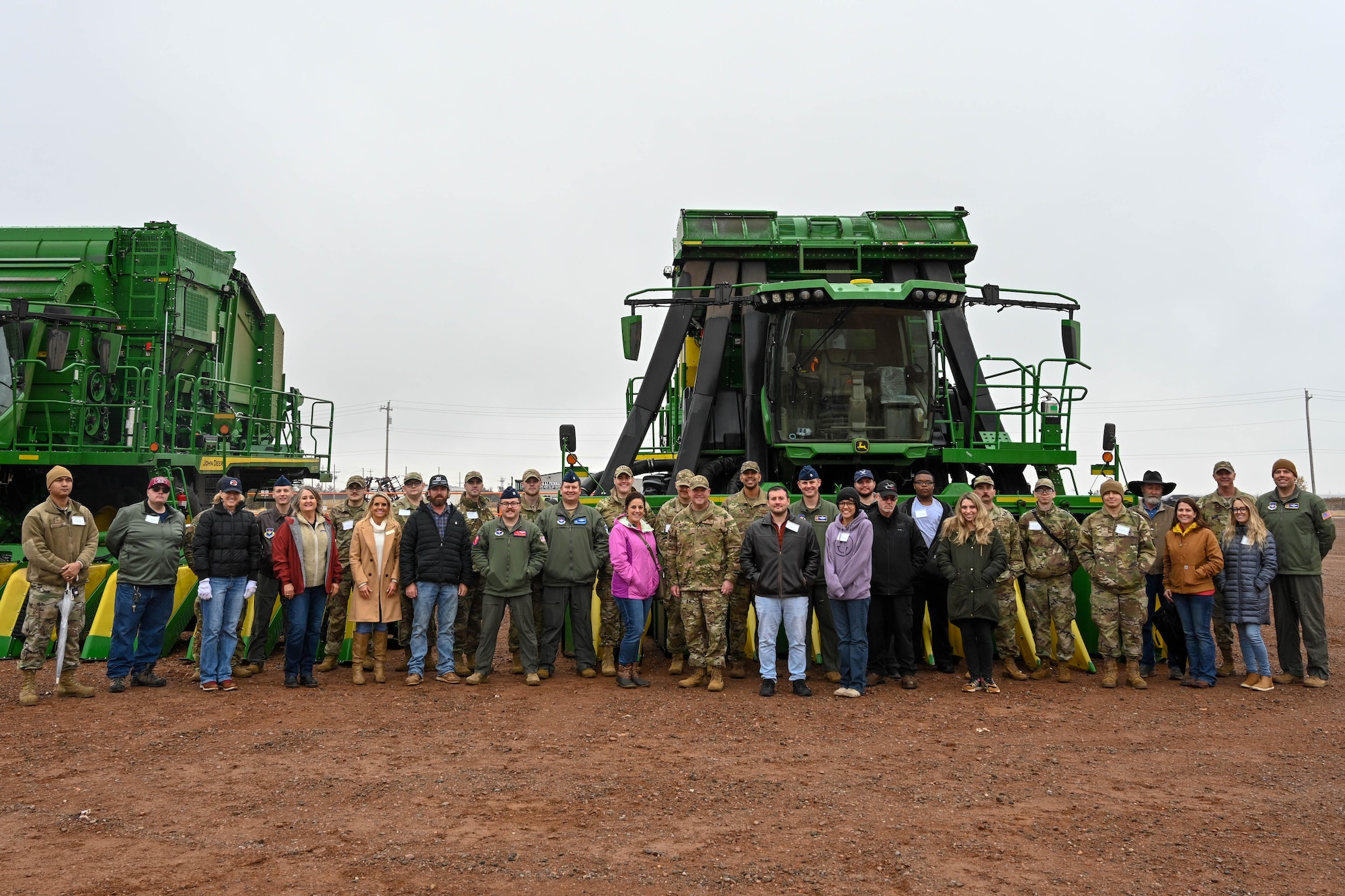 Airmen from the 97th Air Mobility Wing pose for a photo with local community members during an Airpower and Agriculture tour in Altus, Oklahoma, Nov. 30, 2023. This tour, formerly known as “Farm City Week,” was renamed “Airpower and Agriculture” to better reflect the mission and intent of the event, giving Airmen an opportunity to gain an understanding of the local agricultural community, and for the local agricultural community to get a better understanding of the mission at Altus AFB. (U.S. Air Force photo by Senior Airman Trenton Jancze)