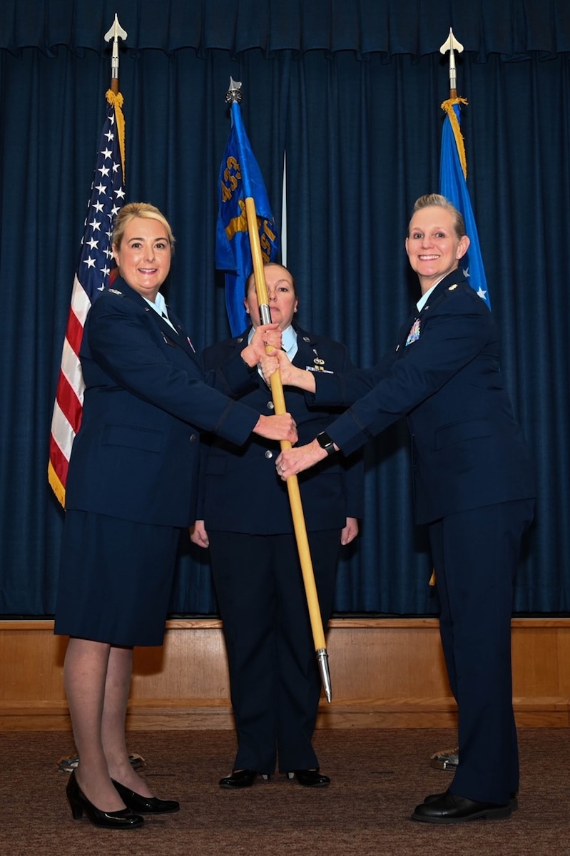 Col. Michelle Van Sickle, 433rd Medical Group commander, presents the 433rd Aeromedical Staging Squadron guidon to Lt. Col. Angella Mudd during an assumption of command ceremony on Joint Base San Antonio-Lackland, Texas, Dec. 2, 2023.