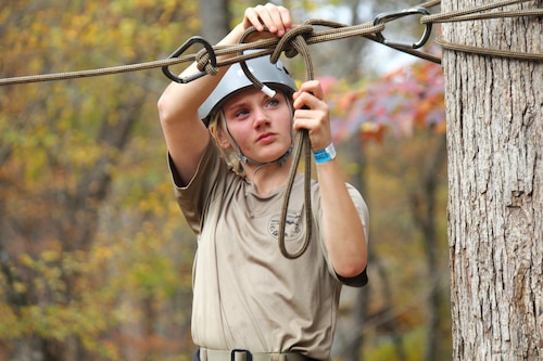 An Air Force Junior ROTC cadet competes in the Rope Bridge event.
