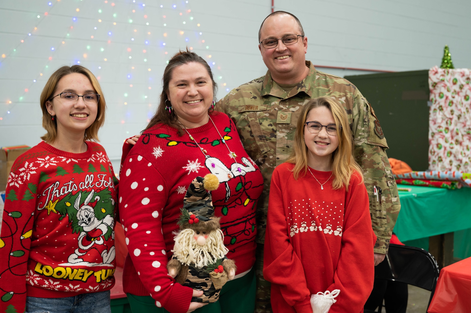Tech. Sgt. Bower and his family pose for a picture with a small festive gnome figurine.