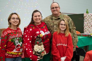 Santa Claus, in an OCP-patterned uniform, waves while standing next to a KC-135R Stratotanker after the children’s Christmas party at Grissom Air Reserve Base, Ind.