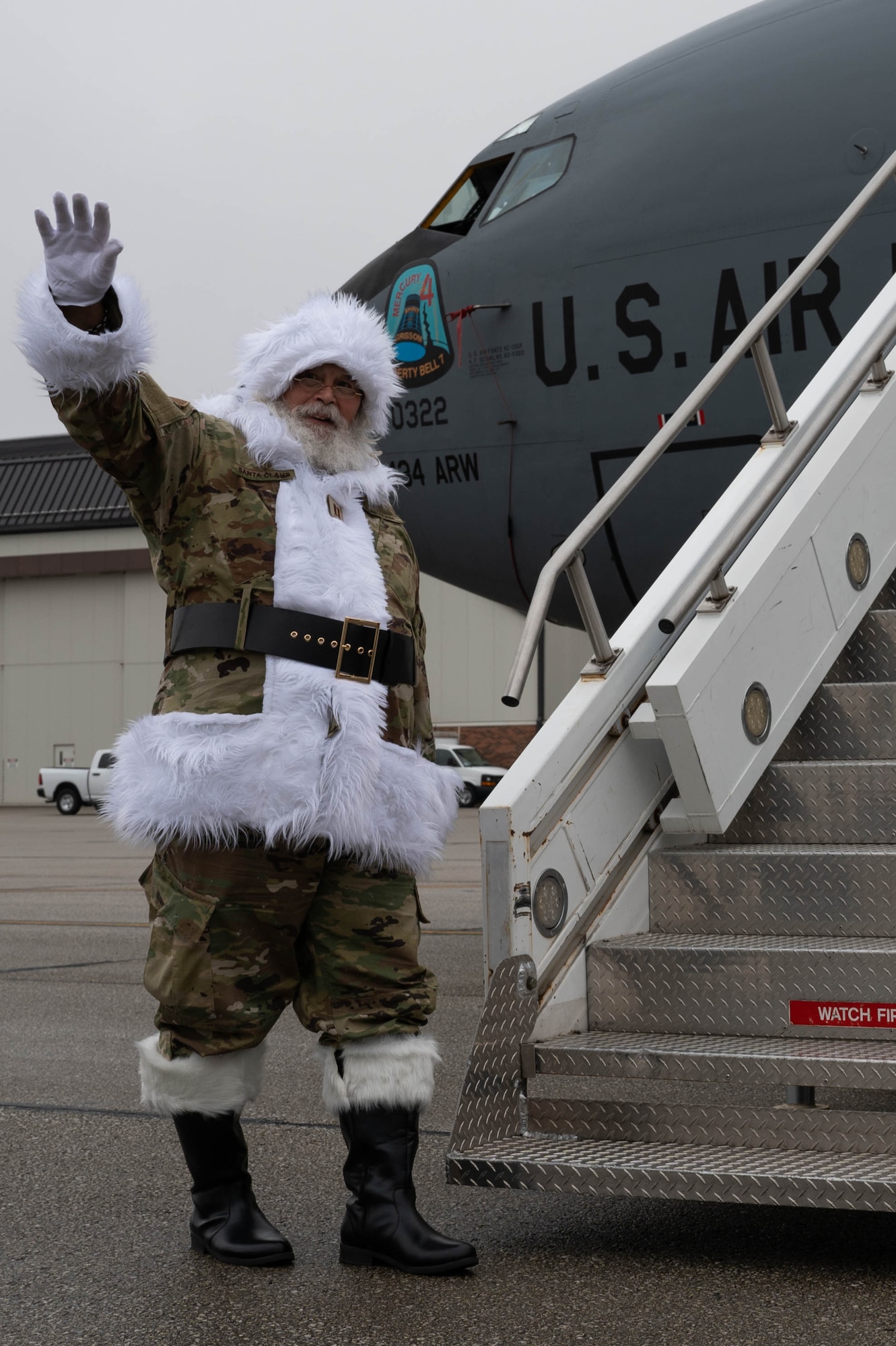 Santa Claus, in an OCP-patterned uniform, waves while standing next to a KC-135R Stratotanker after the children’s Christmas party at Grissom Air Reserve Base, Ind.