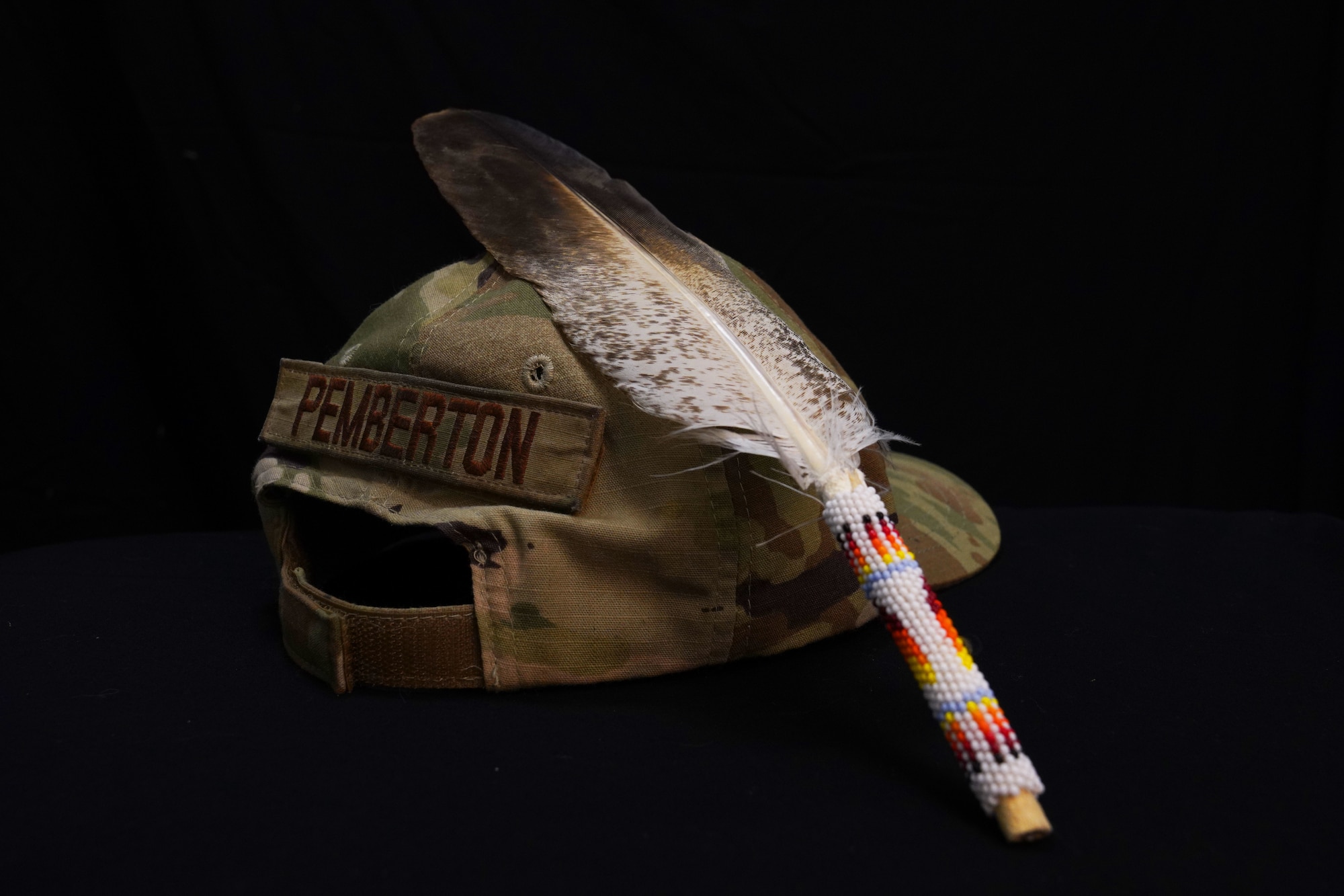 U.S. Air Force Tech. Sgt. Brady Pemberton, 50th Intelligence Squadron signals analyst, OCP tactical hat is shown with a decorated feather against it, Dec. 1, 2023, at Beale Air Force Base, California.