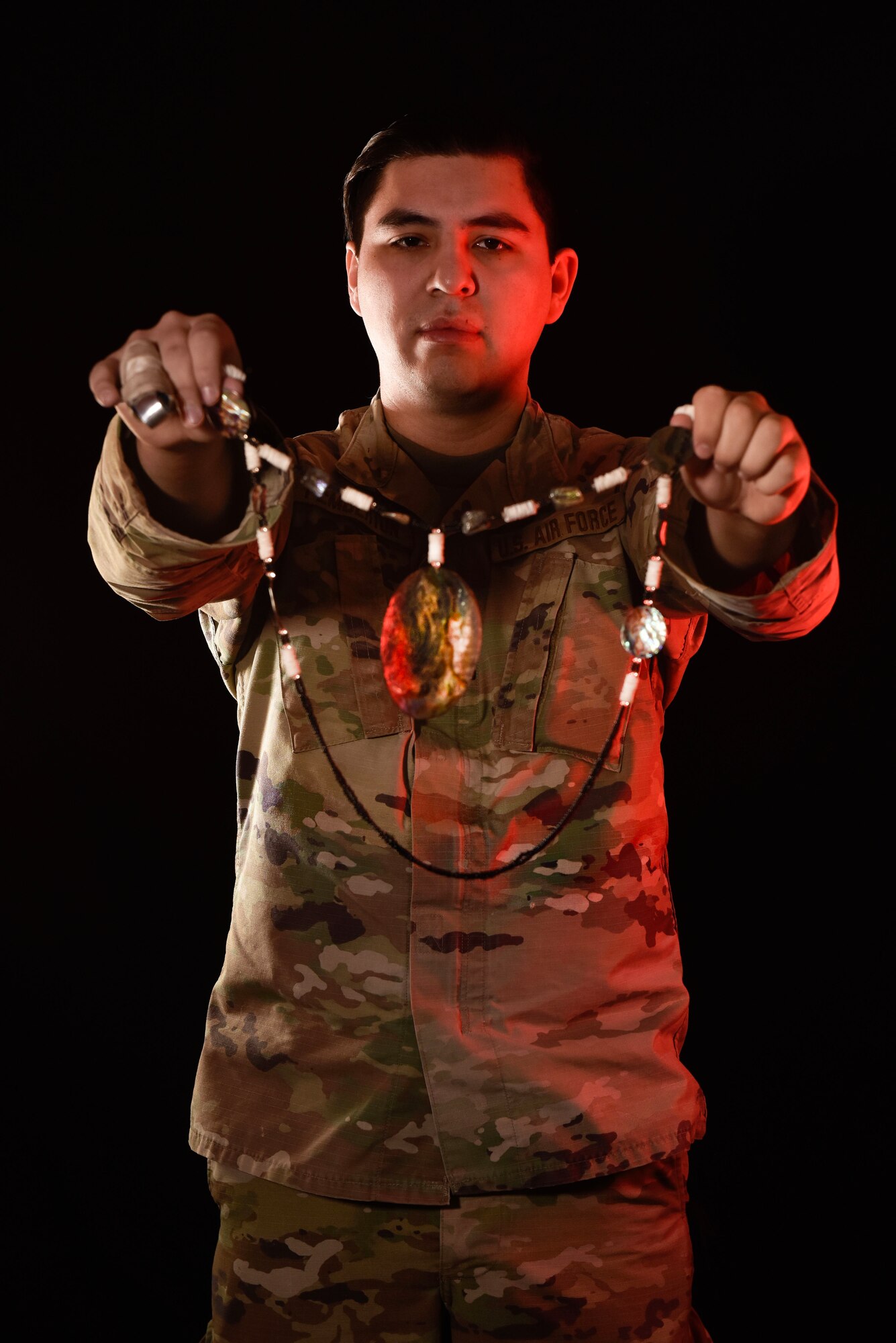 U.S. Air Force Tech. Sgt. Brady Pemberton, 50th Intelligence Squadron signals analyst, holds an abalone necklace, Dec. 1, 2023, at Beale Air Force Base, California.