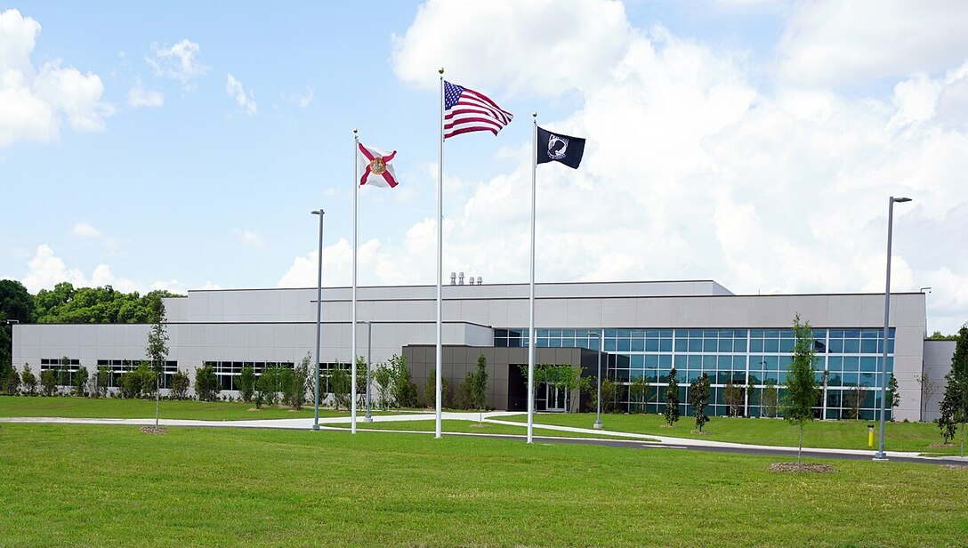 A building with three flags in front of it