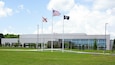 A building with three flags in front of it